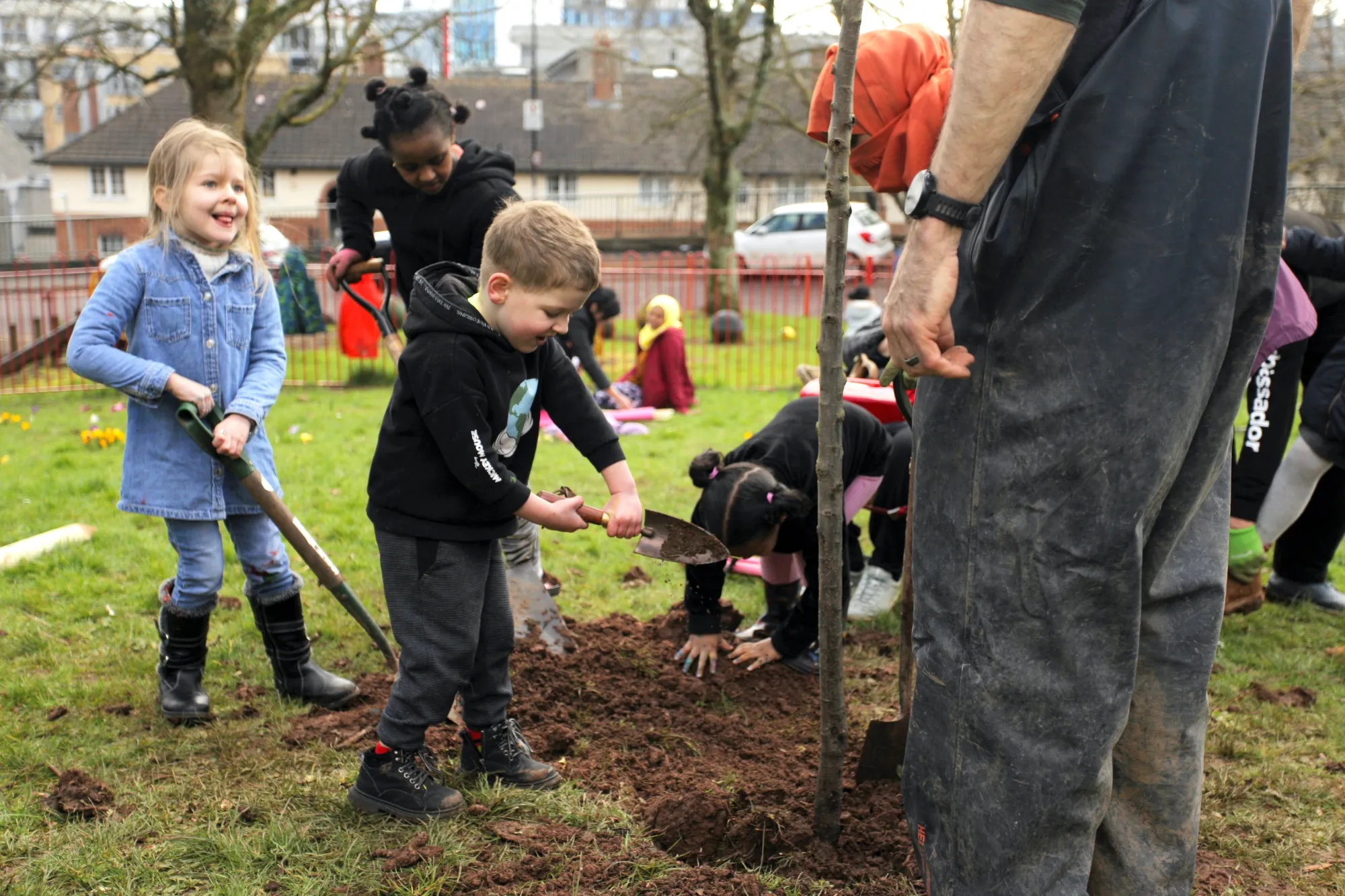 Children planting an apple tree.